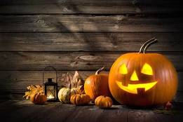 jack o lantern and several small pumpkins